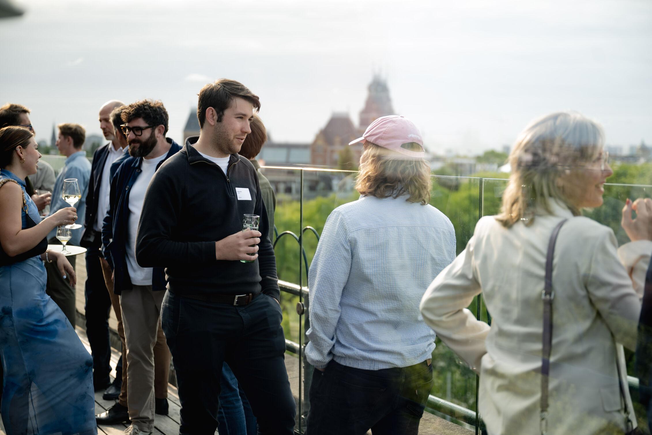 Guests enjoying drinks at the rooftop
